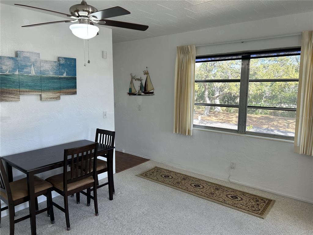 4154 57th Street North, Unit 274 Kenneth City, FL 33709 - Photo 6 of 28 a view of a dining room with furniture and a window