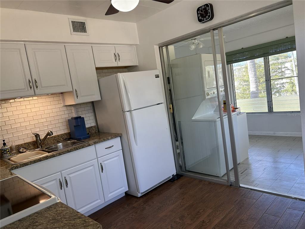 4154 57th Street North, Unit 274 Kenneth City, FL 33709 - Photo 8 of 28 a kitchen with a refrigerator a sink and cabinets