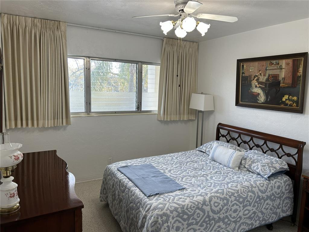 4154 57th Street North, Unit 274 Kenneth City, FL 33709 - Photo 10 of 28 a bedroom with a bed and window