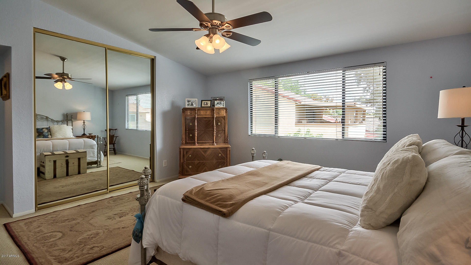 5521 South Rocky Point Road Tempe, AZ 85283 - Photo 21 of 38 a bedroom with a bed and a chandelier