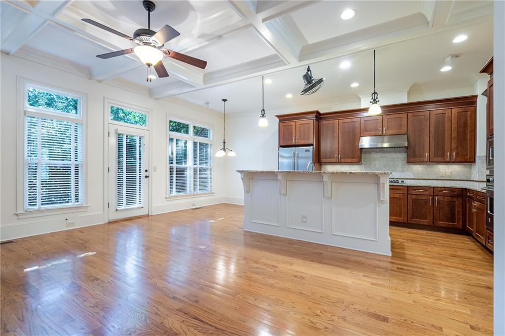 12 Candler Grove Drive Decatur, GA 30030 - Photo 11 of 33 a large kitchen with stainless steel appliances granite countertop a stove top oven a sink dishwasher a dining table and chairs with wooden floor