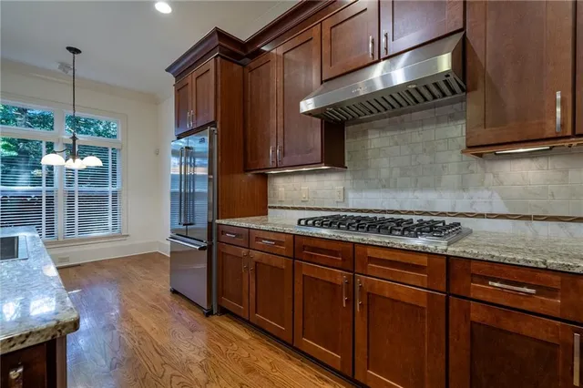 a kitchen with wooden cabinets and a stove top oven