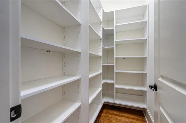 a view of walk in closet with empty racks