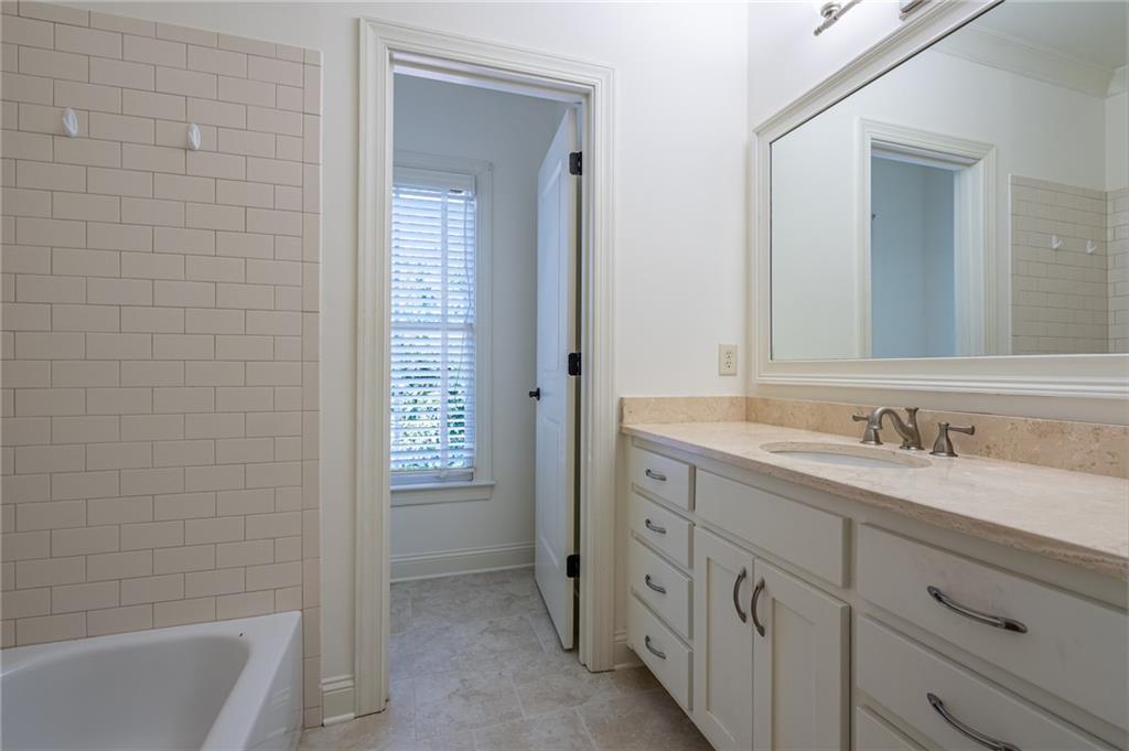 12 Candler Grove Drive Decatur, GA 30030 - Photo 20 of 33 a bathroom with a granite countertop sink mirror and a bathtub