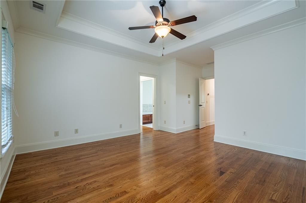 12 Candler Grove Drive Decatur, GA 30030 - Photo 24 of 33 an empty room with wooden floor and a ceiling fan