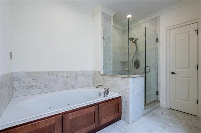 a bathroom with a bathtub and a shower
