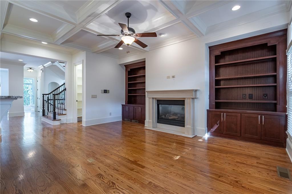 12 Candler Grove Drive Decatur, GA 30030 - Photo 10 of 33 a view of a livingroom with a fireplace a chandelier and wooden floor