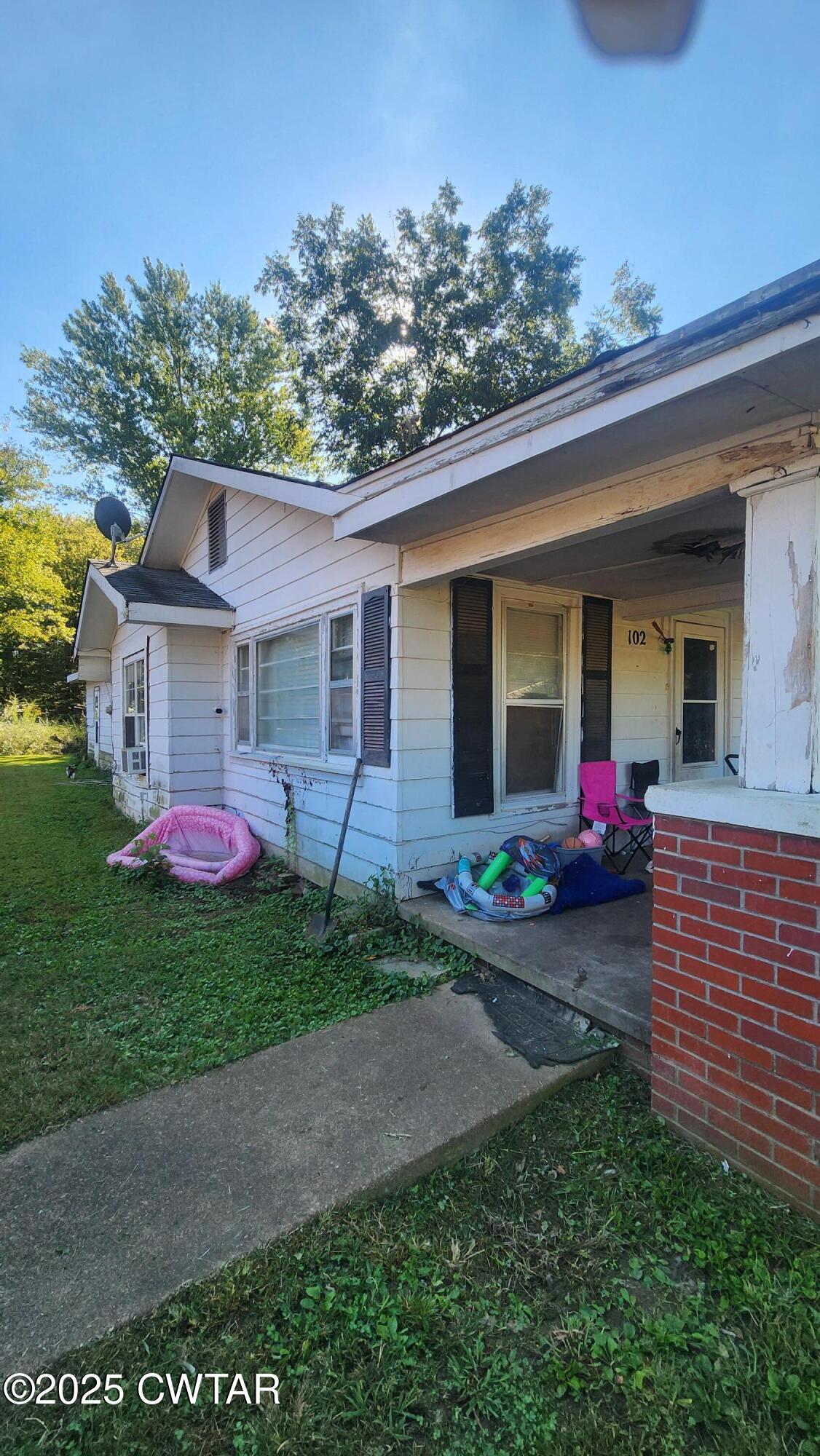 102 Rhea Street Jackson, TN 38301 - Photo 2 of 3 a front view of a house with yard and outdoor seating