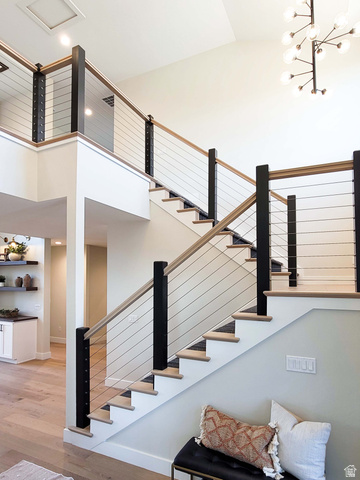 Open-tread staircase with wood-finish steps and cable railing