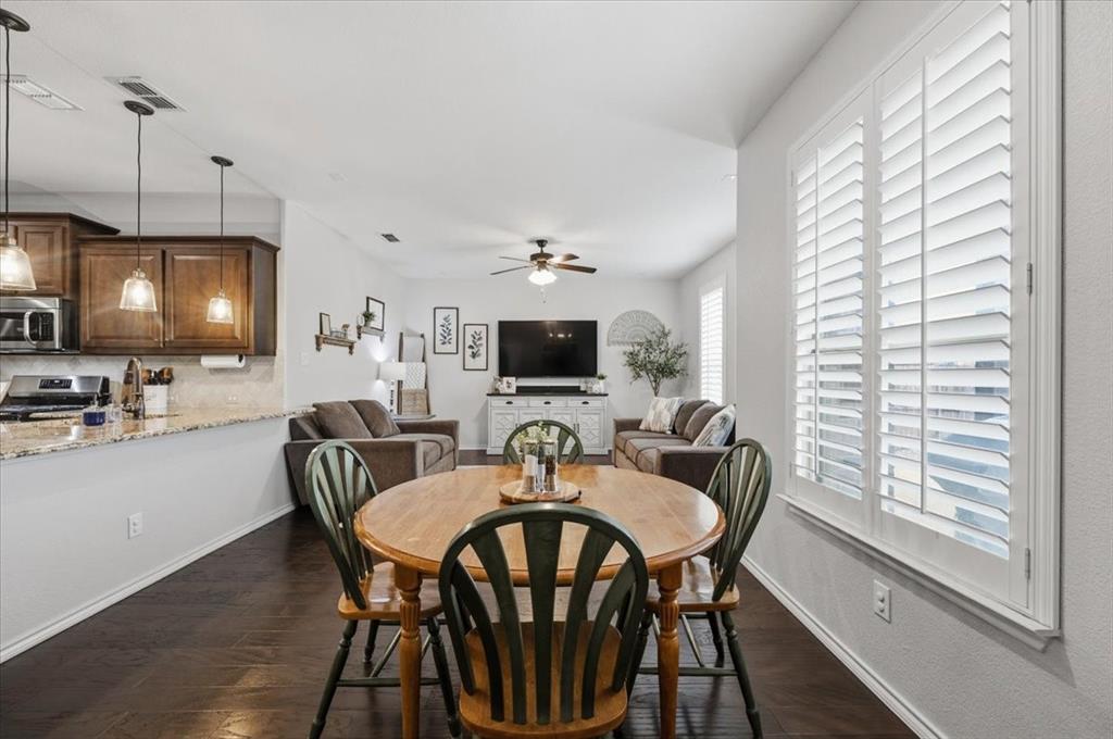 448 Spring Drive Saginaw, TX 76131 - Photo 17 of 40 a view of a dining room with furniture and wooden floor