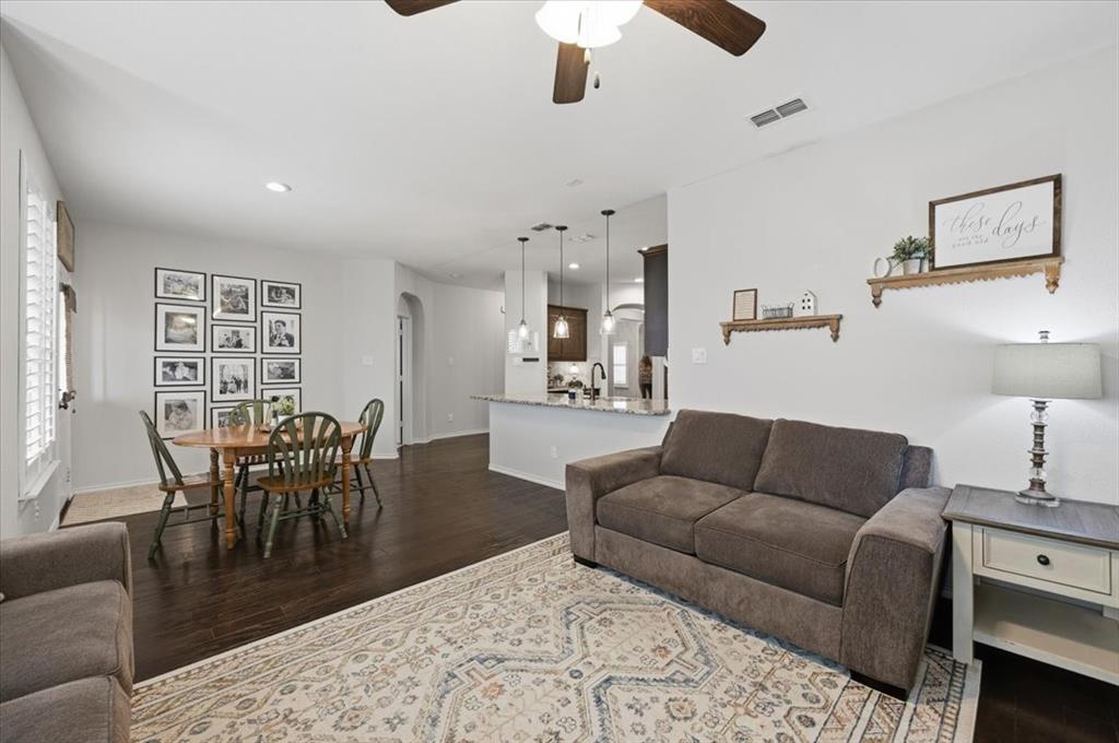 448 Spring Drive Saginaw, TX 76131 - Photo 21 of 40 a living room with furniture wooden floor and a dining table