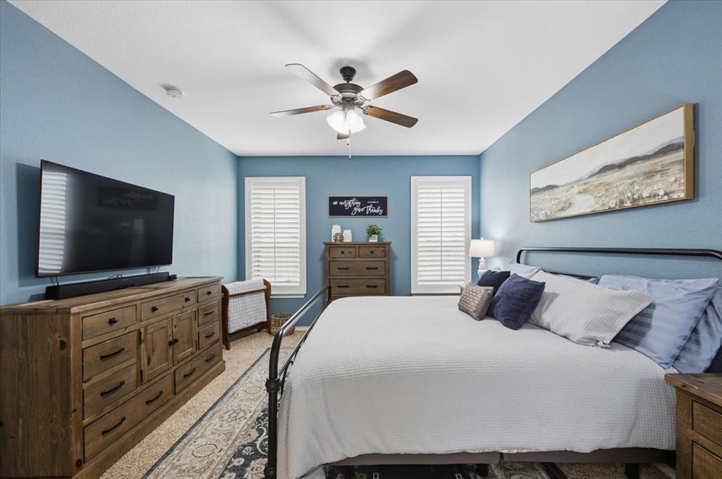 448 Spring Drive Saginaw, TX 76131 - Photo 24 of 40 a bedroom with a bed and a flat screen tv
