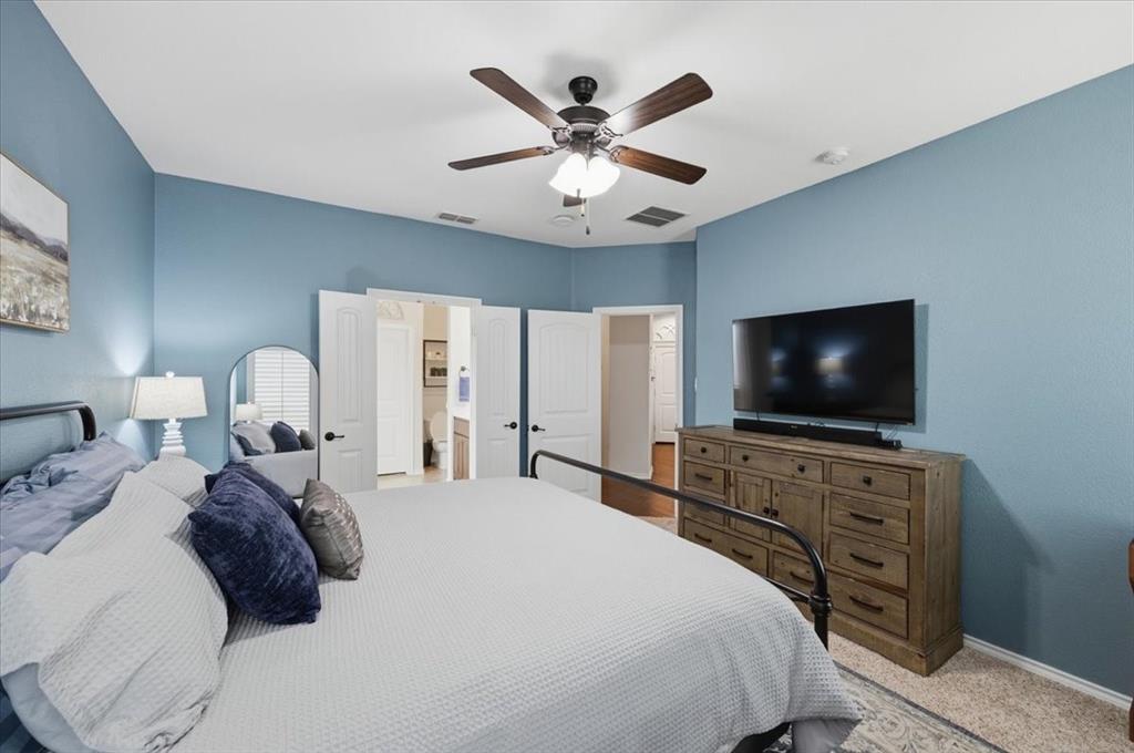 448 Spring Drive Saginaw, TX 76131 - Photo 25 of 40 a bedroom with a bed and a flat screen tv