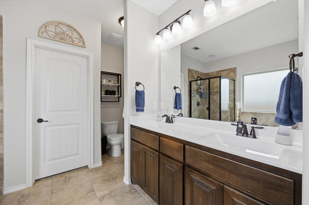 448 Spring Drive Saginaw, TX 76131 - Photo 26 of 40 a bathroom with double vanity sinks and a mirror