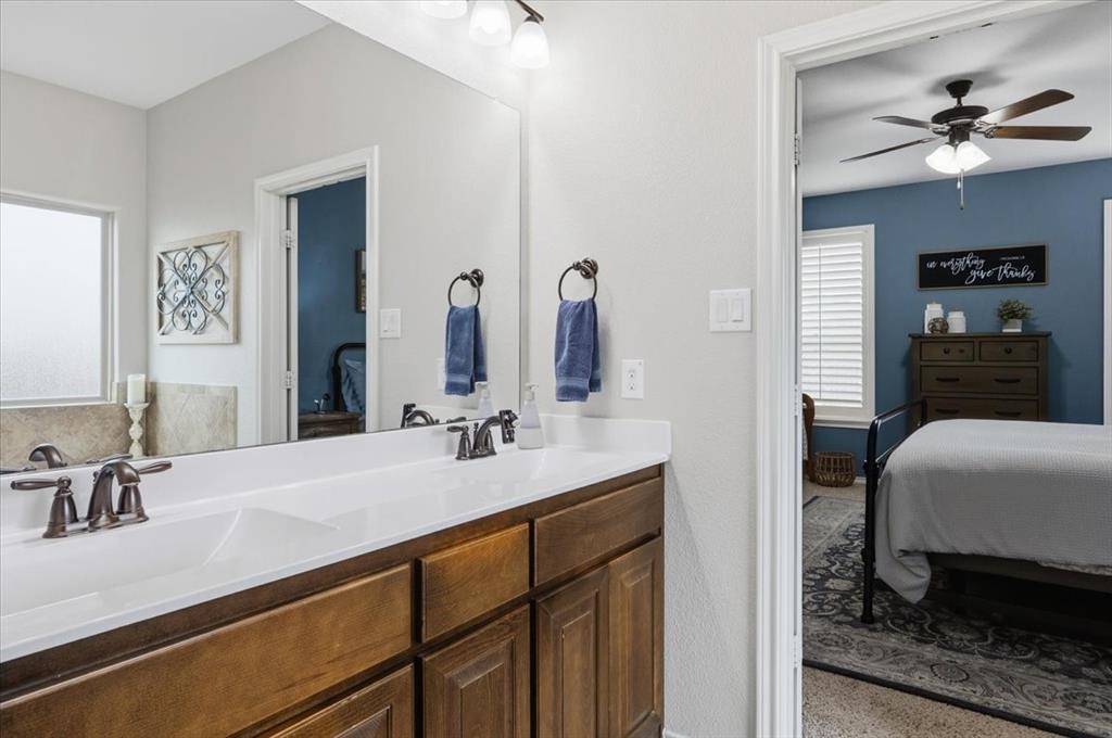 448 Spring Drive Saginaw, TX 76131 - Photo 29 of 40 a en suite bathroom with a sink double vanity and a mirror