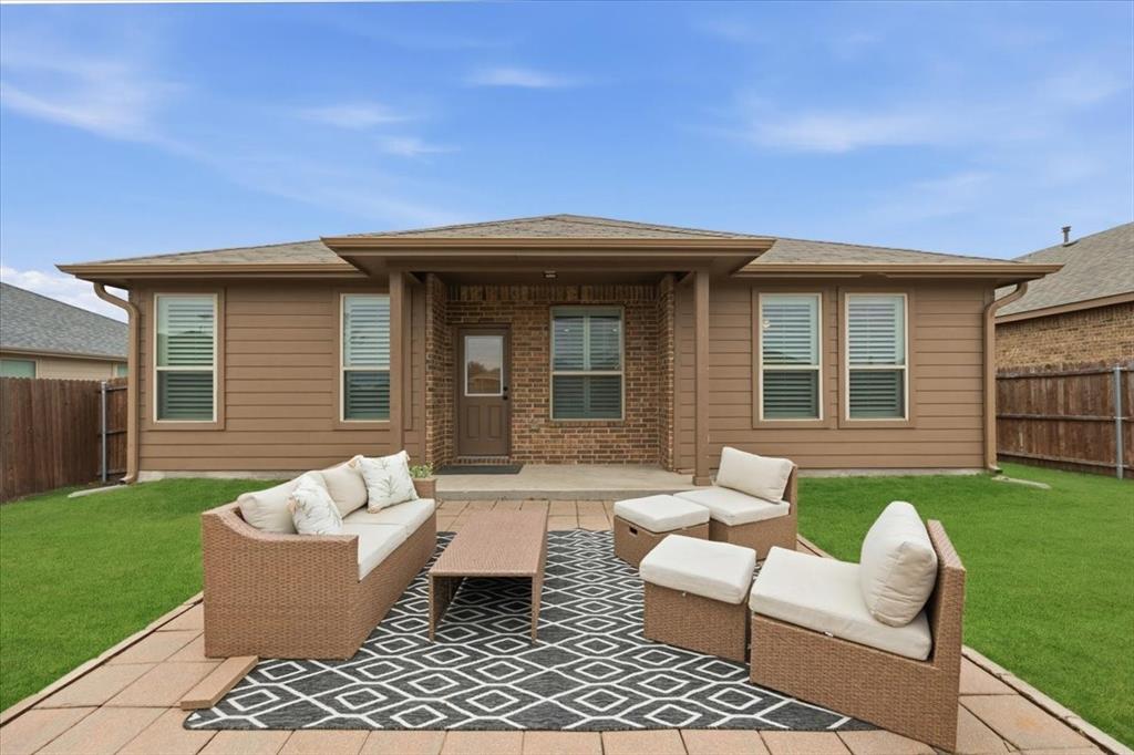 448 Spring Drive Saginaw, TX 76131 - Photo 36 of 40 a view of a patio with couches chairs and potted plants