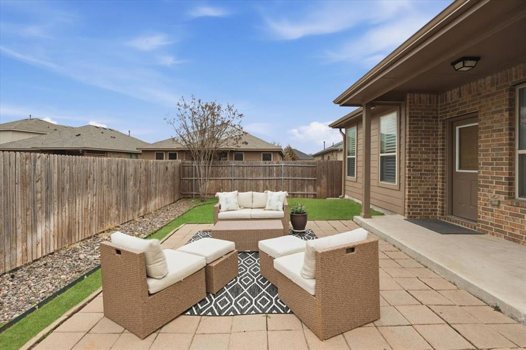 448 Spring Drive Saginaw, TX 76131 - Photo 37 of 40 a view of a patio with couches table and chairs and potted plants