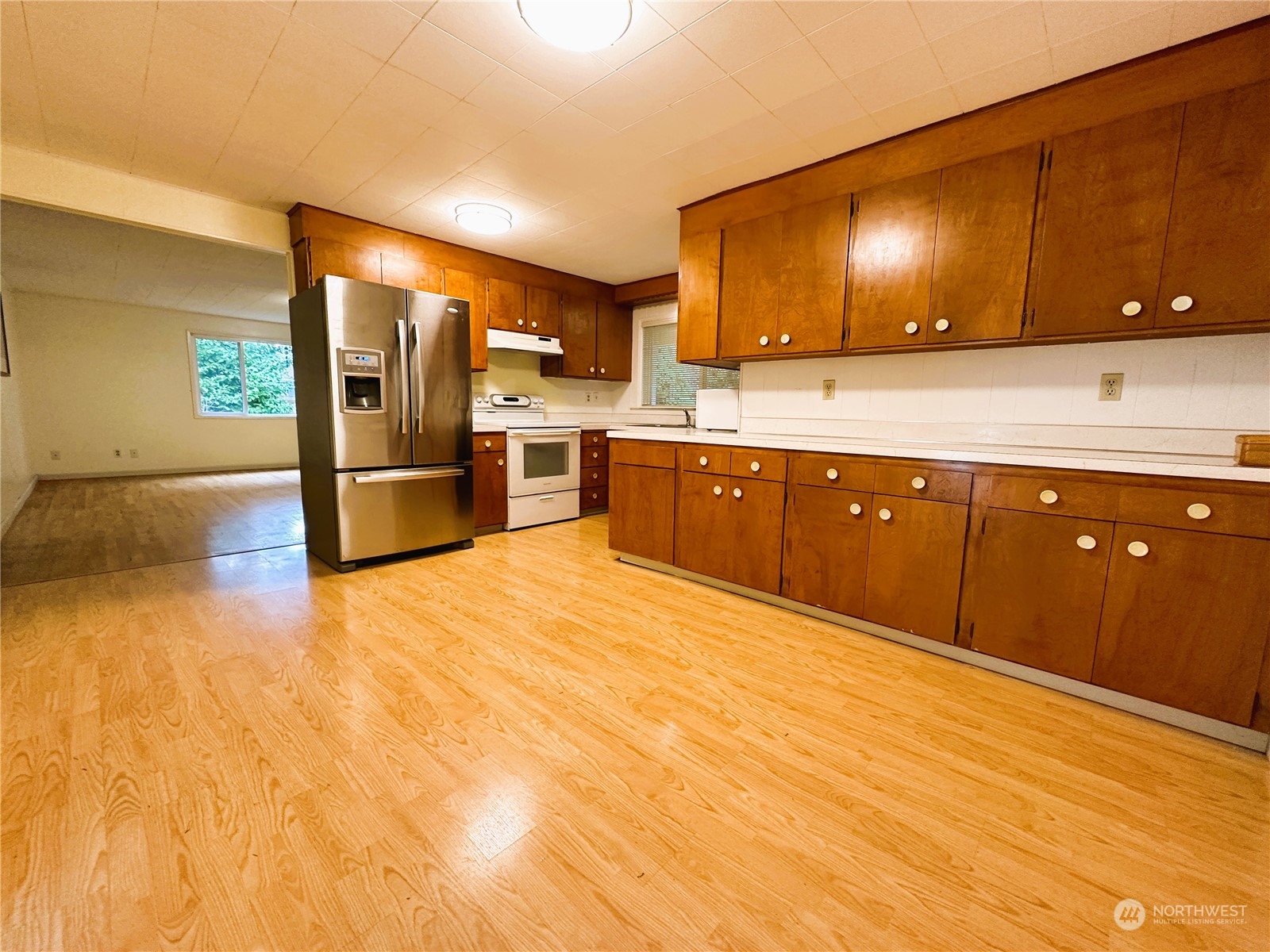 12429 Southeast 95th Way Renton, WA 98056 - Photo 2 of 15 a large kitchen with stainless steel appliances granite countertop a sink and cabinets