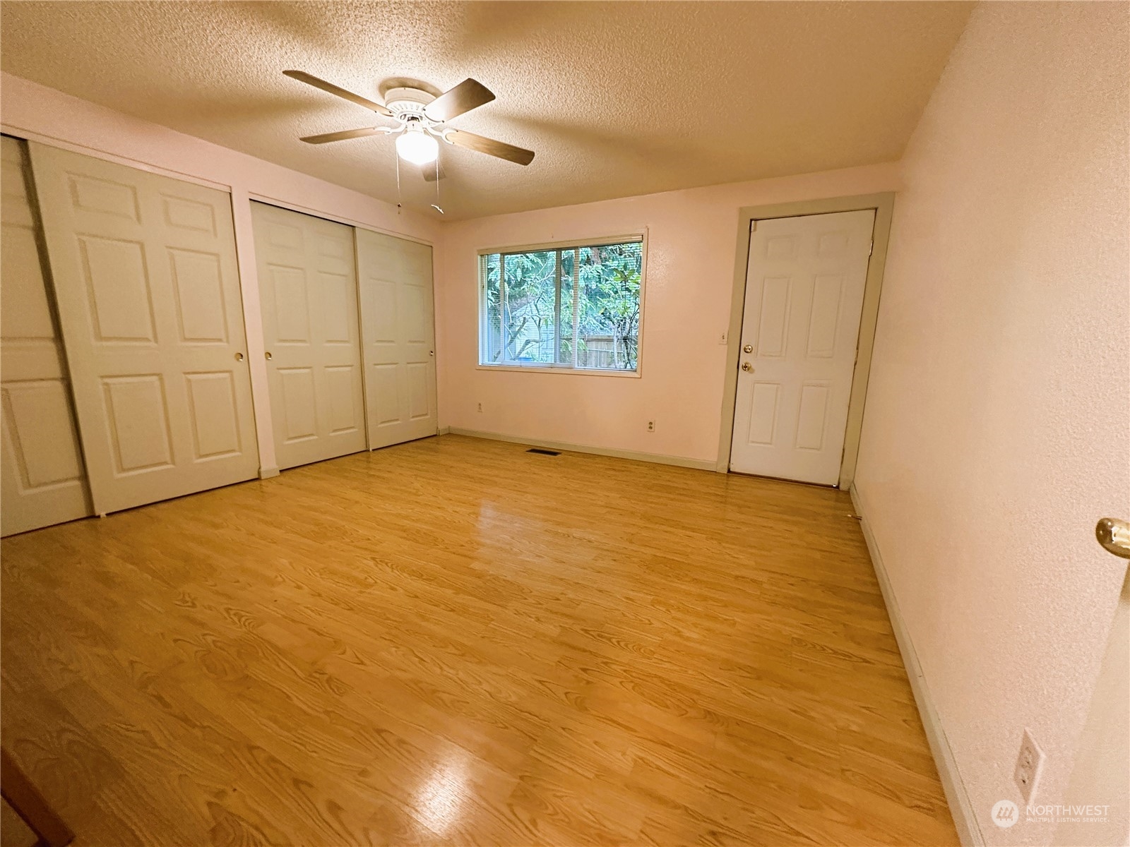 12429 Southeast 95th Way Renton, WA 98056 - Photo 3 of 15 wooden floor in an empty room with a window