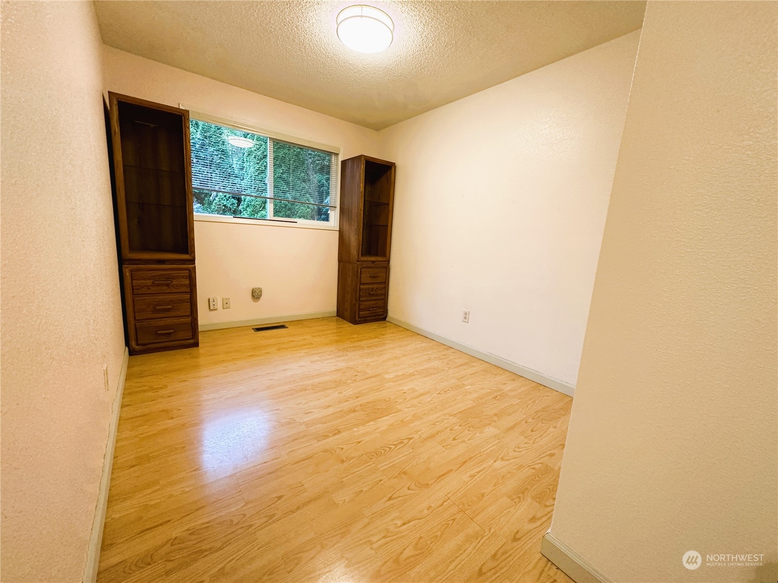 12429 Southeast 95th Way Renton, WA 98056 - Photo 6 of 15 a view of empty room with wooden floor and fan