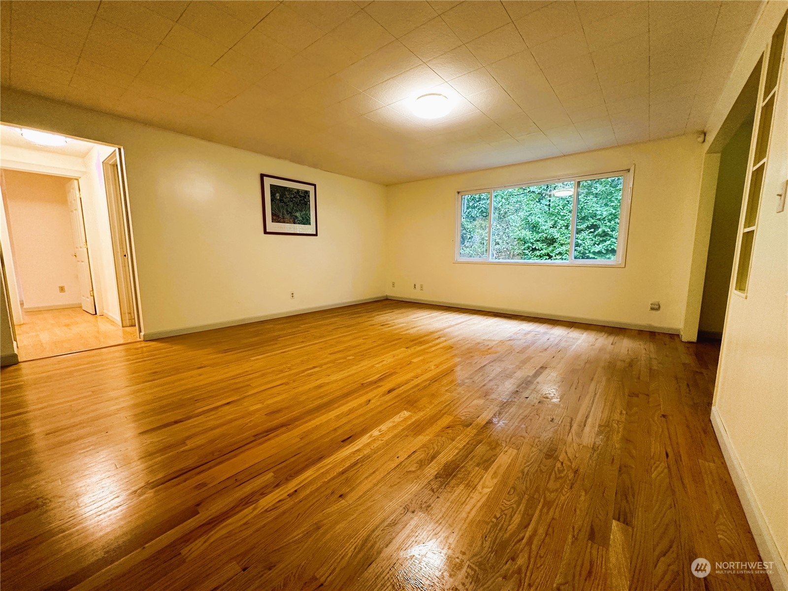 12429 Southeast 95th Way Renton, WA 98056 - Photo 8 of 15 an empty room with wooden floor and windows