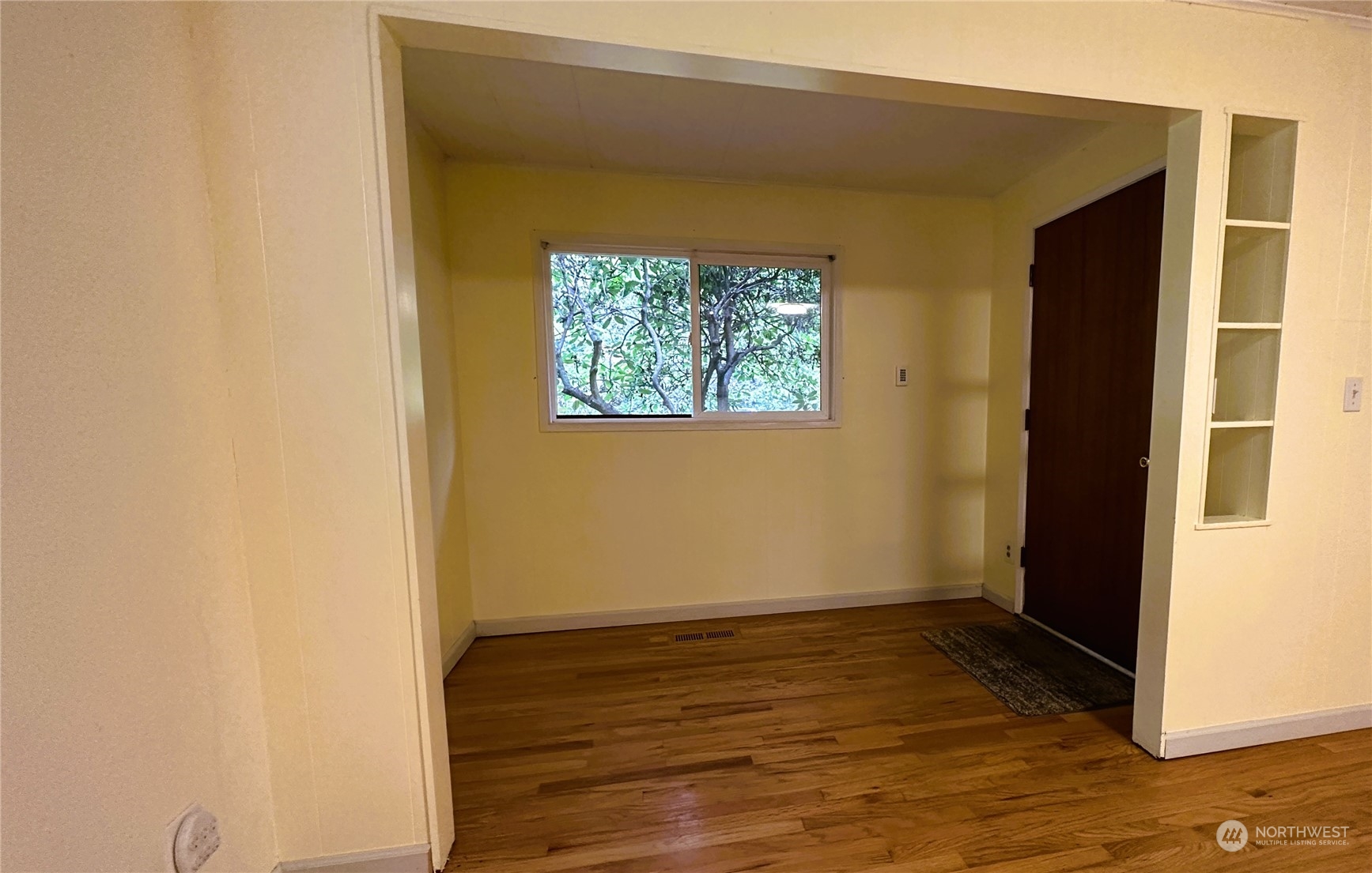12429 Southeast 95th Way Renton, WA 98056 - Photo 9 of 15 a view of an empty room with wooden floor and a window