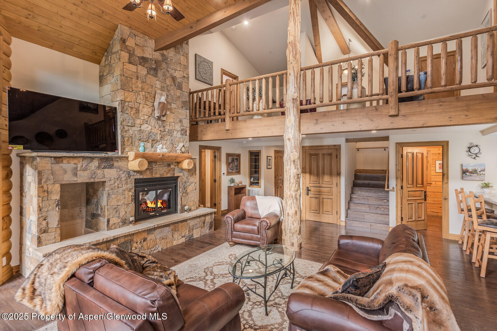 175 Bison Lane Redstone, CO 81623 - Photo 19 of 60 a living room with furniture a flat screen tv and a fireplace