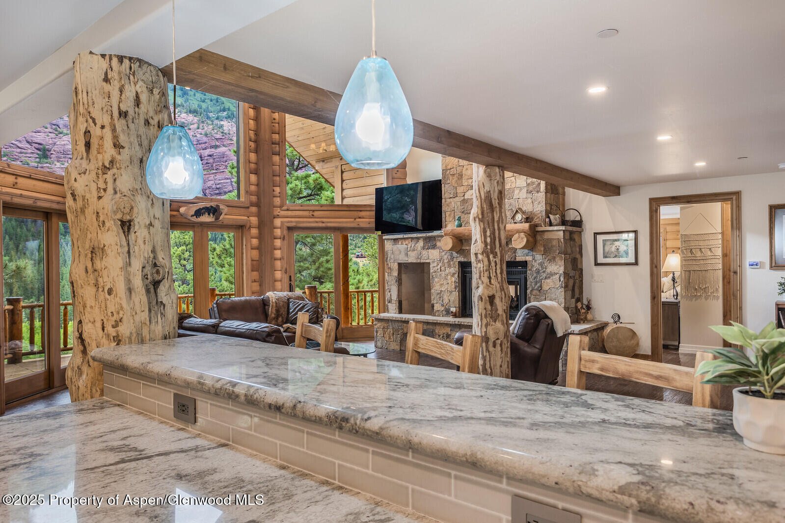 175 Bison Lane Redstone, CO 81623 - Photo 22 of 60 a living room with furniture a large window and a chandelier