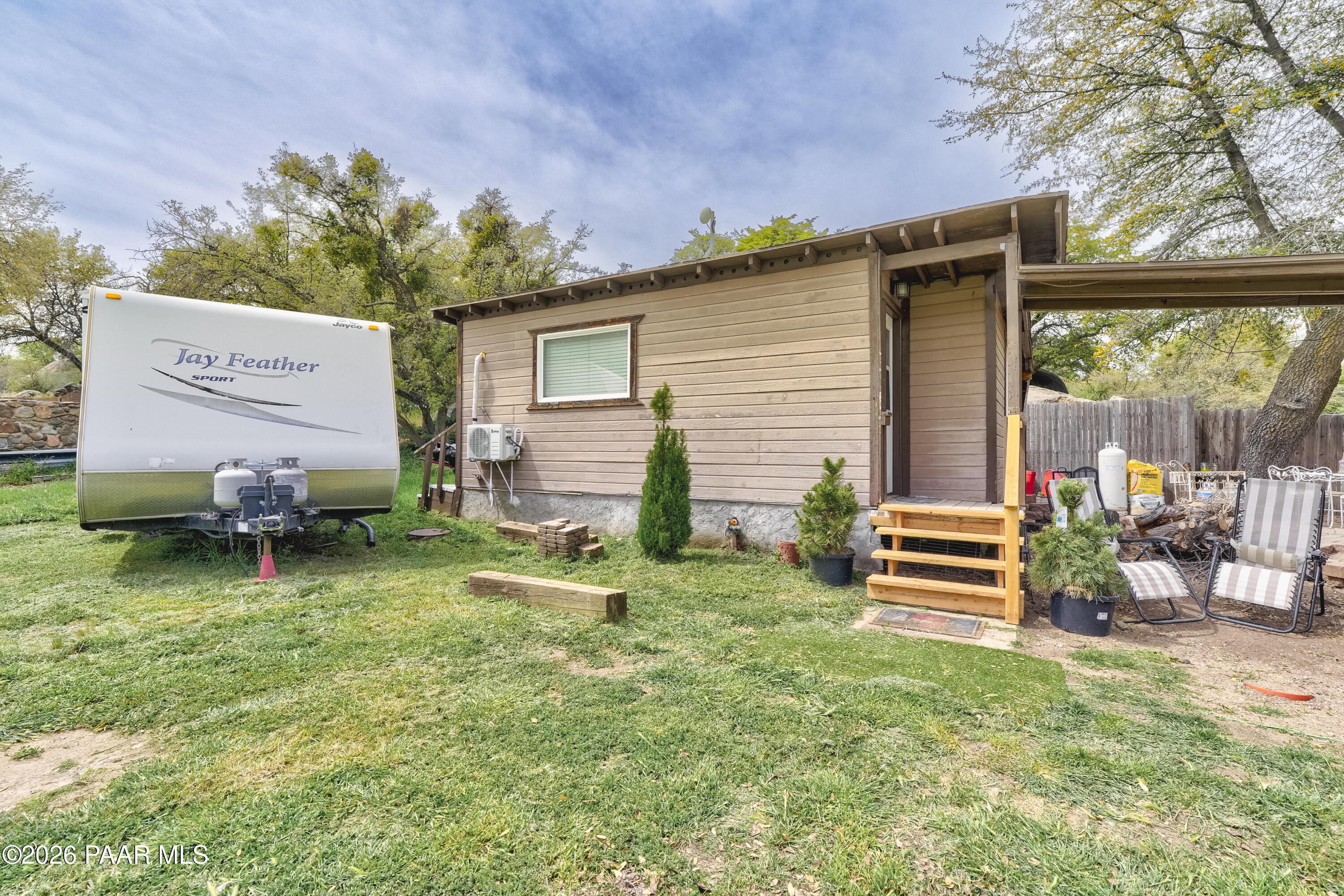 22584 Stone Way Yarnell, AZ 85362 - Photo 23 of 36 a backyard of a house with barbeque oven table and chairs
