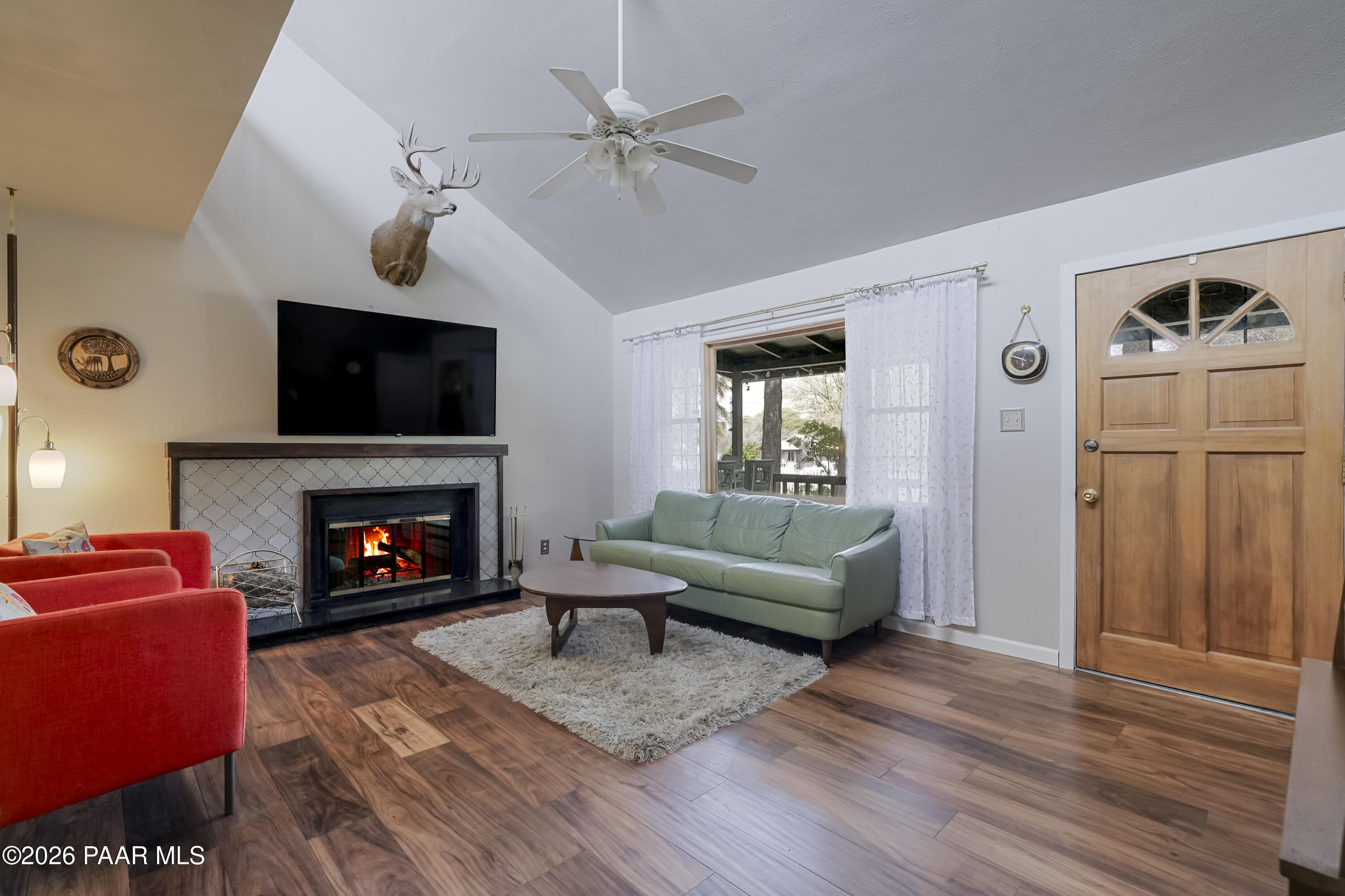 22584 Stone Way Yarnell, AZ 85362 - Photo 6 of 36 a living room with furniture a flat screen tv and a fireplace