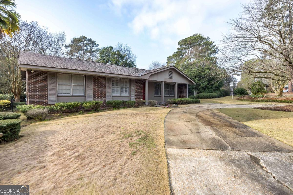 2836 Cromwell Drive Columbus, GA 31906 - Photo 1 of 34 a front view of a house with a yard and potted plants
