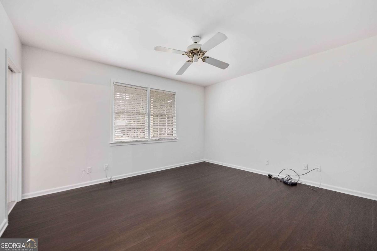 2836 Cromwell Drive Columbus, GA 31906 - Photo 22 of 34 an empty room with wooden floor fan and windows