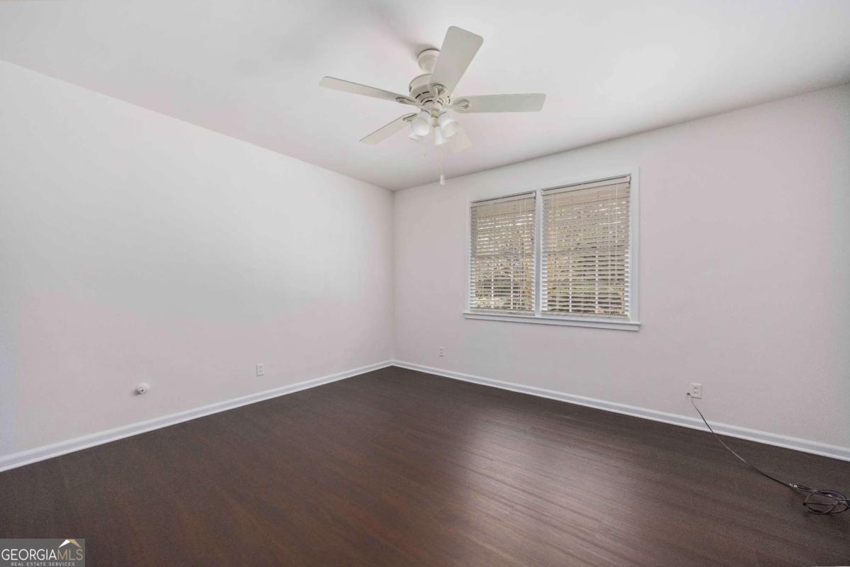 2836 Cromwell Drive Columbus, GA 31906 - Photo 23 of 34 an empty room with wooden floor fan and windows