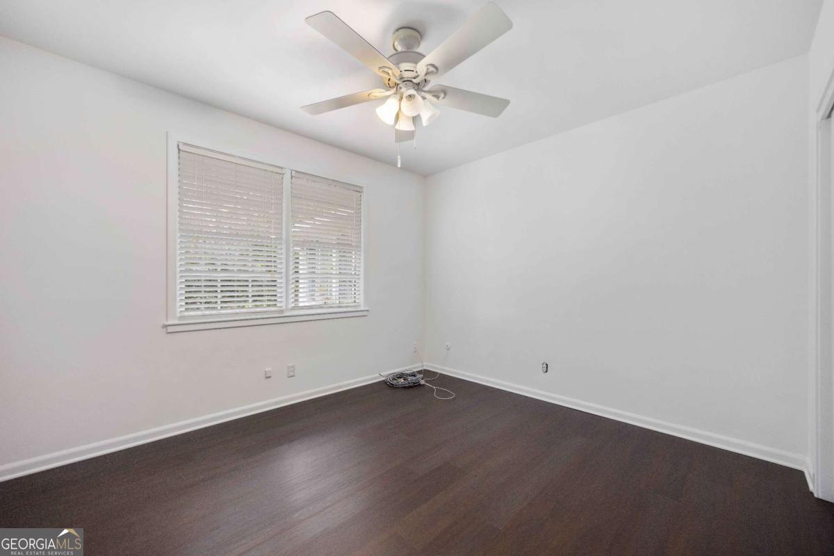 2836 Cromwell Drive Columbus, GA 31906 - Photo 24 of 34 an empty room with a chandelier fan and windows