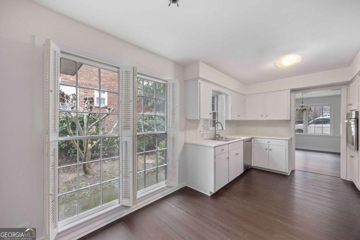 2836 Cromwell Drive Columbus, GA 31906 - Photo 10 of 34 a kitchen with white cabinets and wooden floor