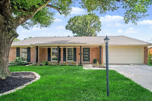 a view of a house with a yard and sitting area
