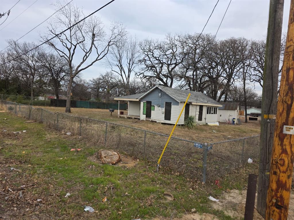 3422 Peachtree Road Balch Springs, TX 75180 - Photo 6 of 17 a view of a yard in front of a house with large trees