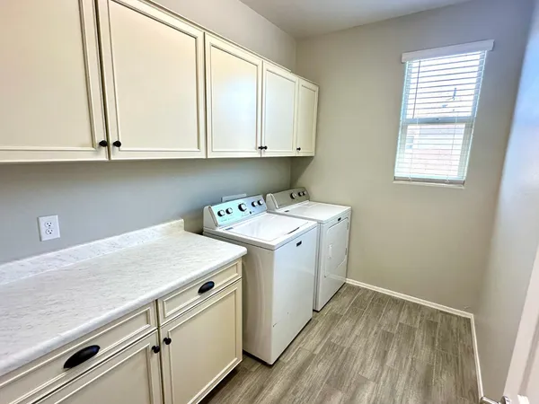 an empty room with closet and a chandelier fan