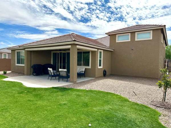 a view of house with backyard and porch