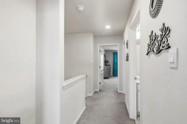 a bedroom with a bed dresser and a large window