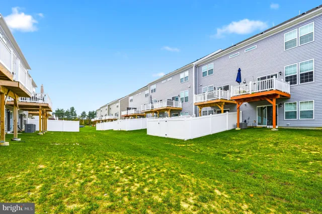 a view of a house with patio and a yard