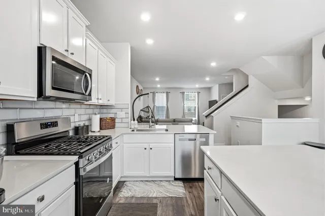 a kitchen with sink cabinets and wooden floor
