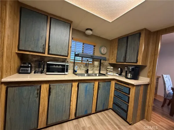 a kitchen with wooden cabinets and a sink