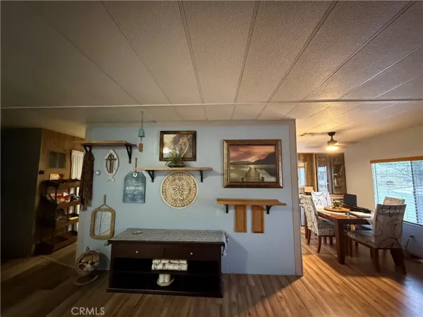 a view of a dining room with furniture kitchen and wooden floor