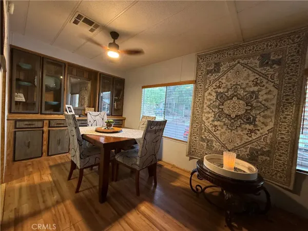 a view of a dining room with furniture window and wooden floor