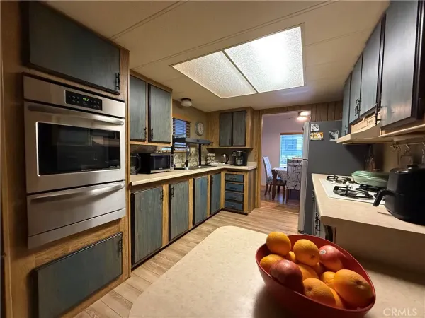a kitchen with stainless steel appliances kitchen island granite countertop a sink counter space cabinets and stainless steel appliances