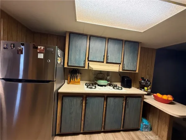 a kitchen with a refrigerator and a sink