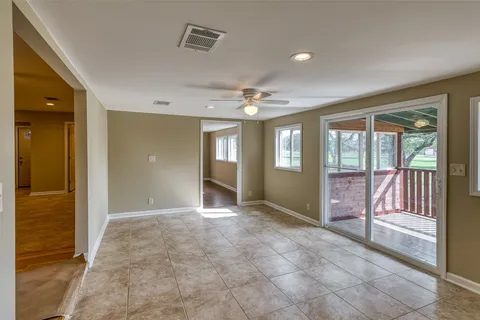 a view of an empty room with closet and a window