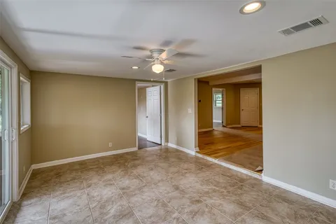 a view of a livingroom with a ceiling fan and window