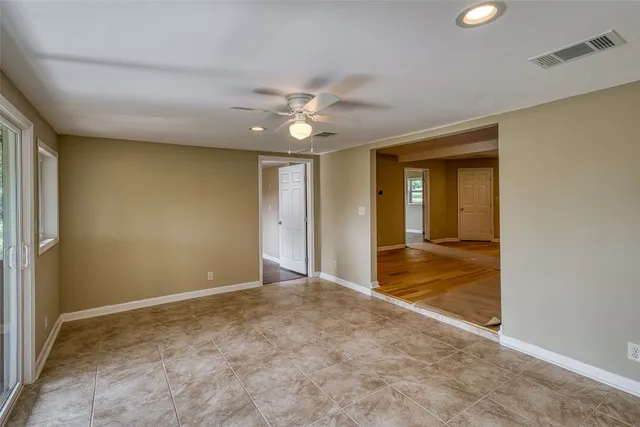 a view of a livingroom with a ceiling fan and window